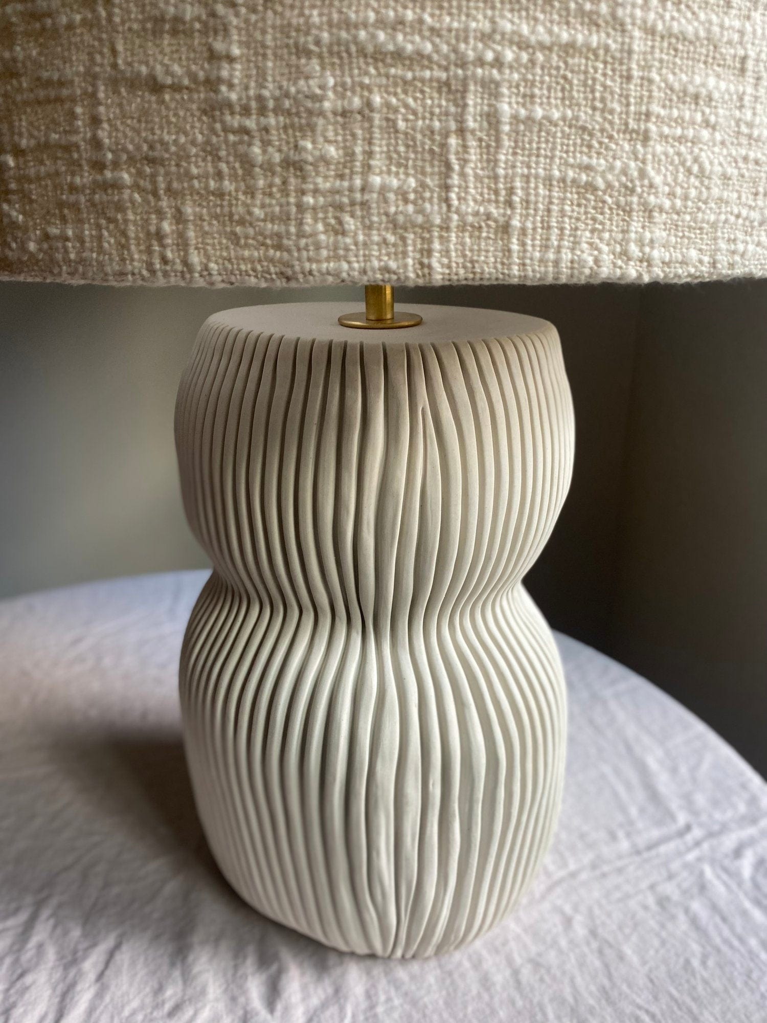 White textured table lamp with woven shade.