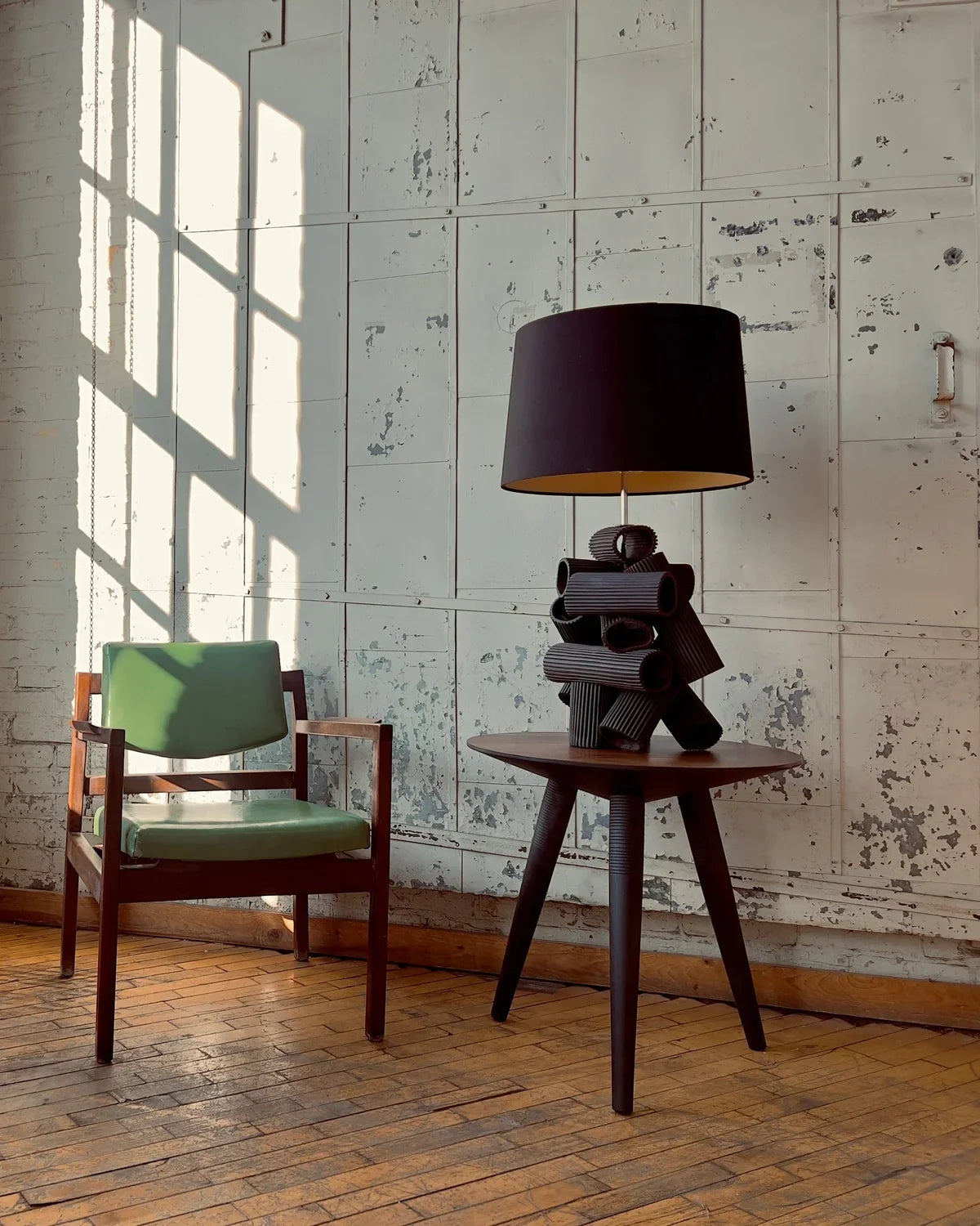 Chair, table with lamp, and sunlight on wall
