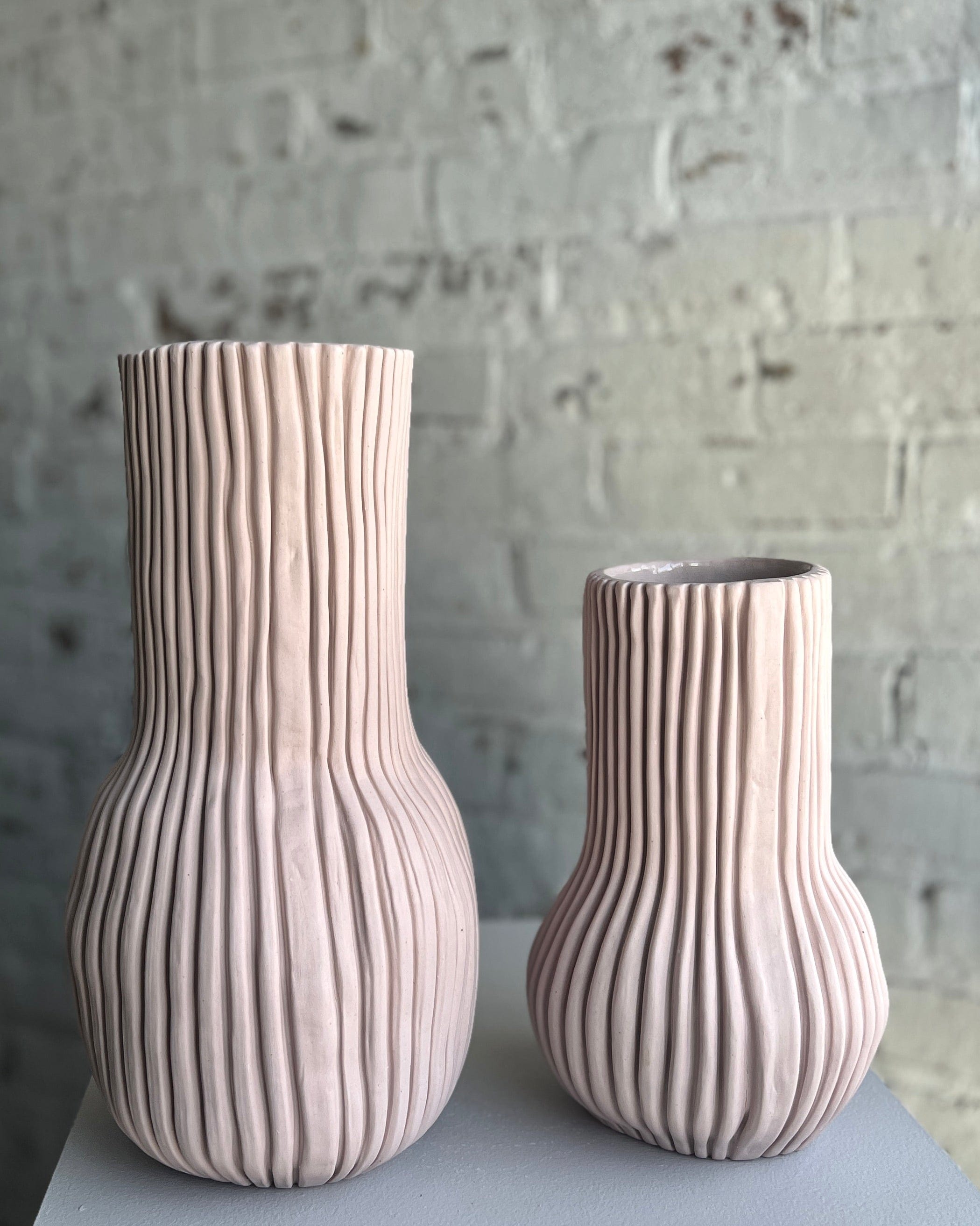 Two textured pink ceramic vases