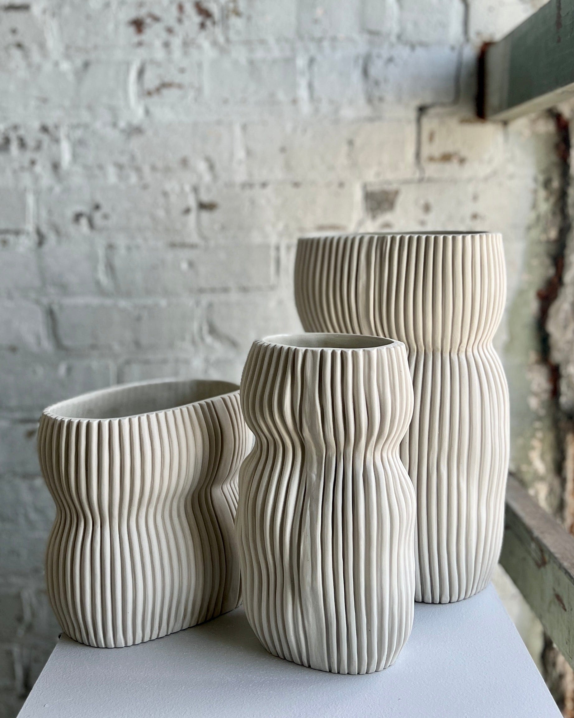 Three ribbed ceramic vases