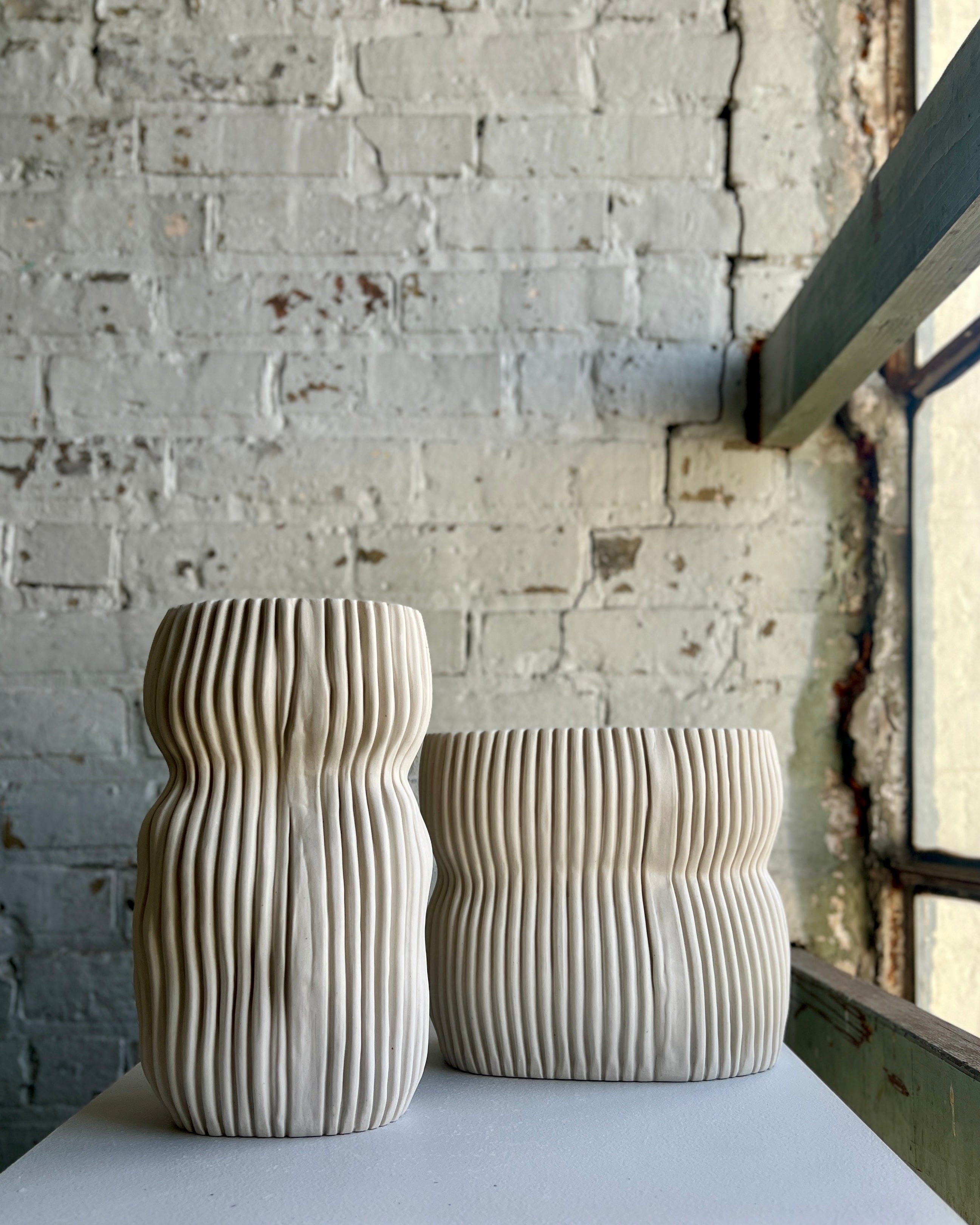 Two ribbed ceramic vases.