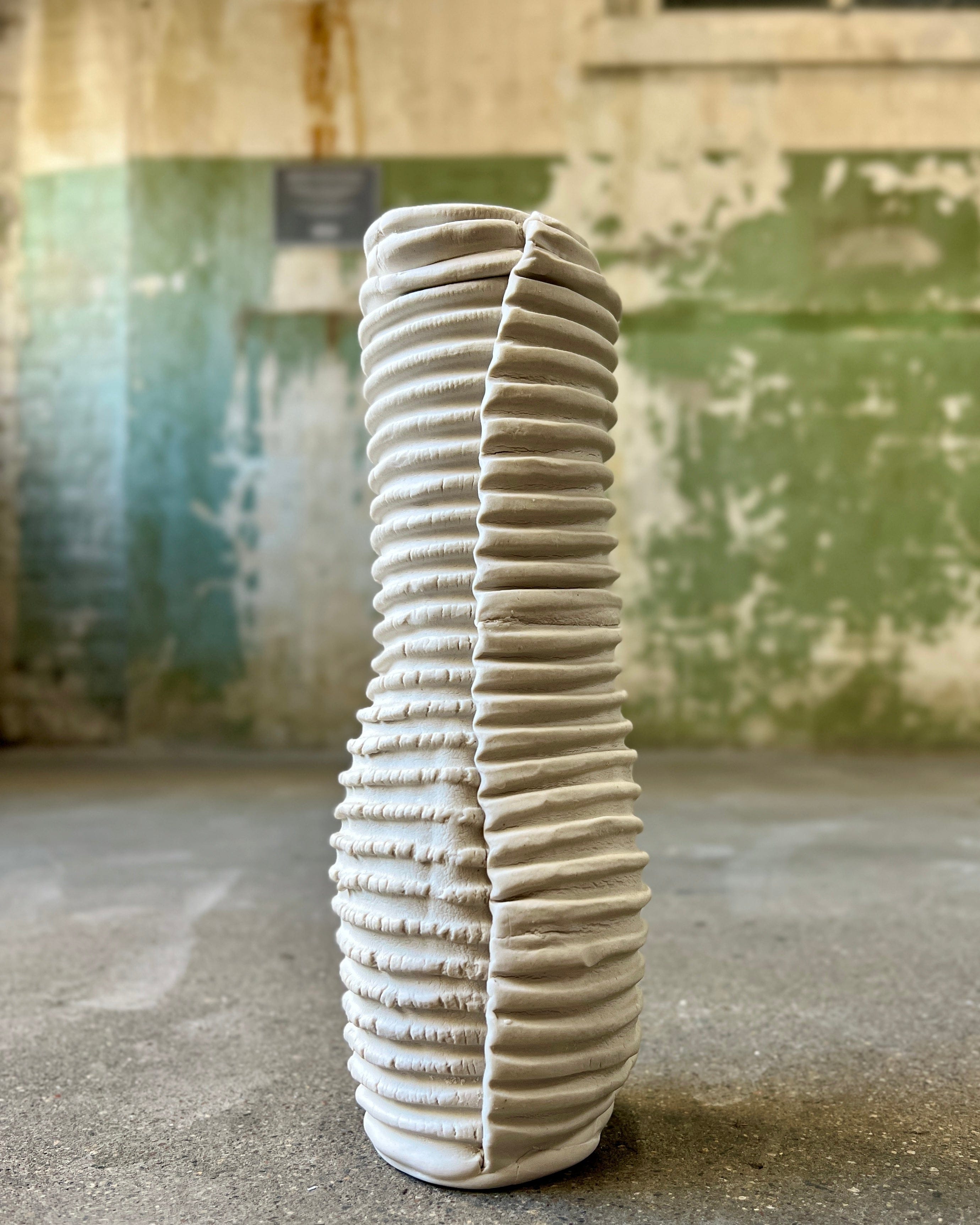 White, textured ceramic vase.