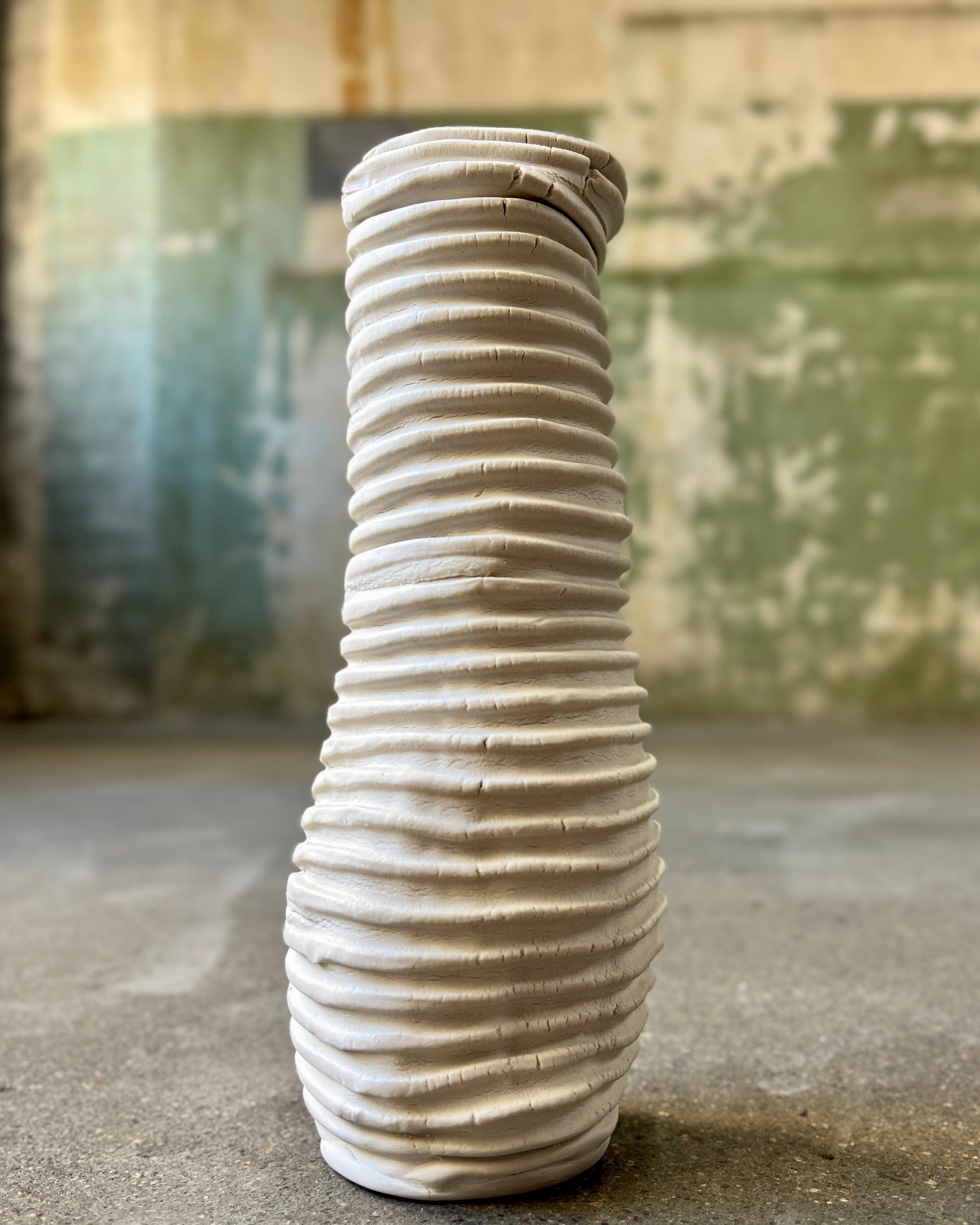 White, ridged ceramic vase.