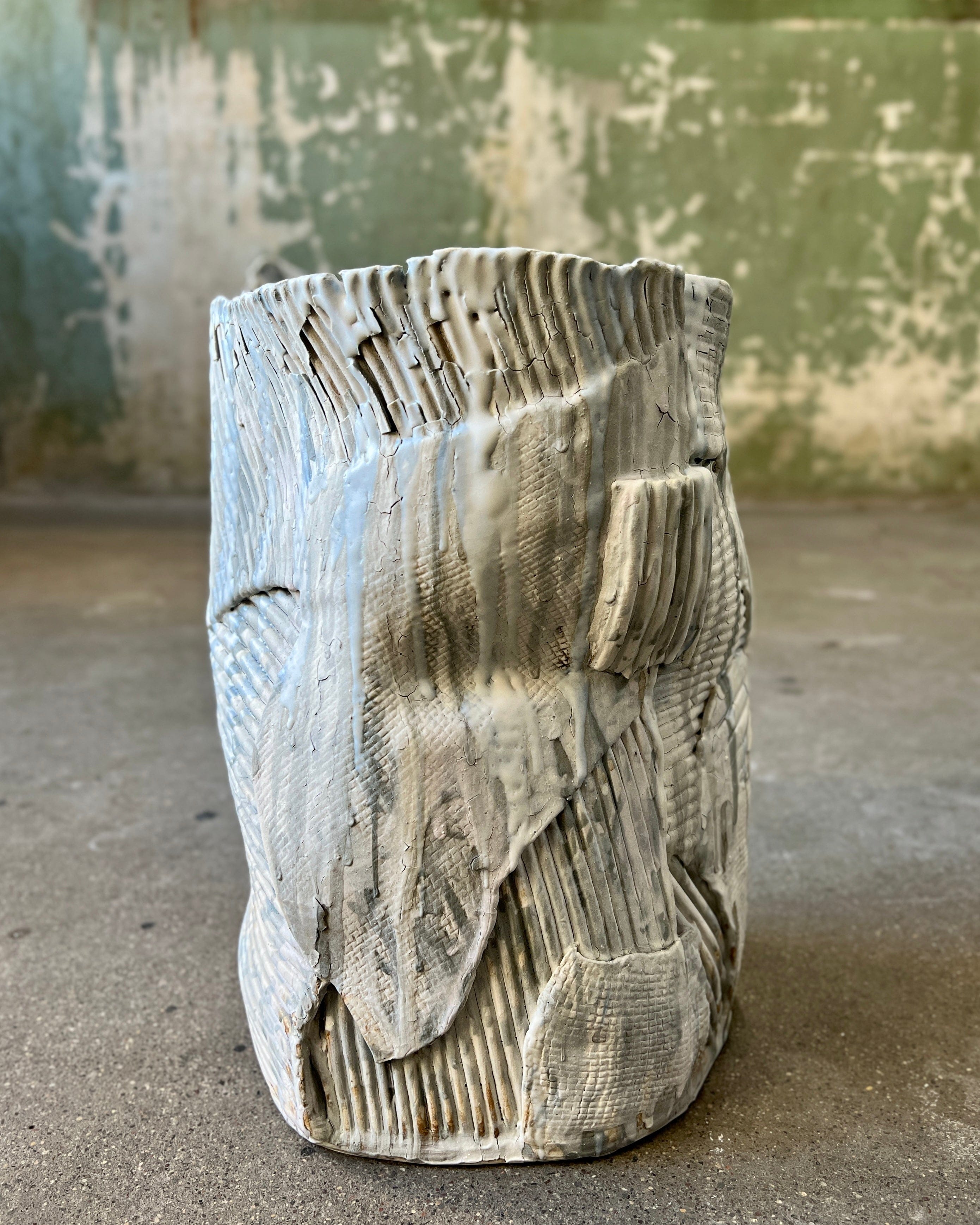 Textured, gray ceramic vase.