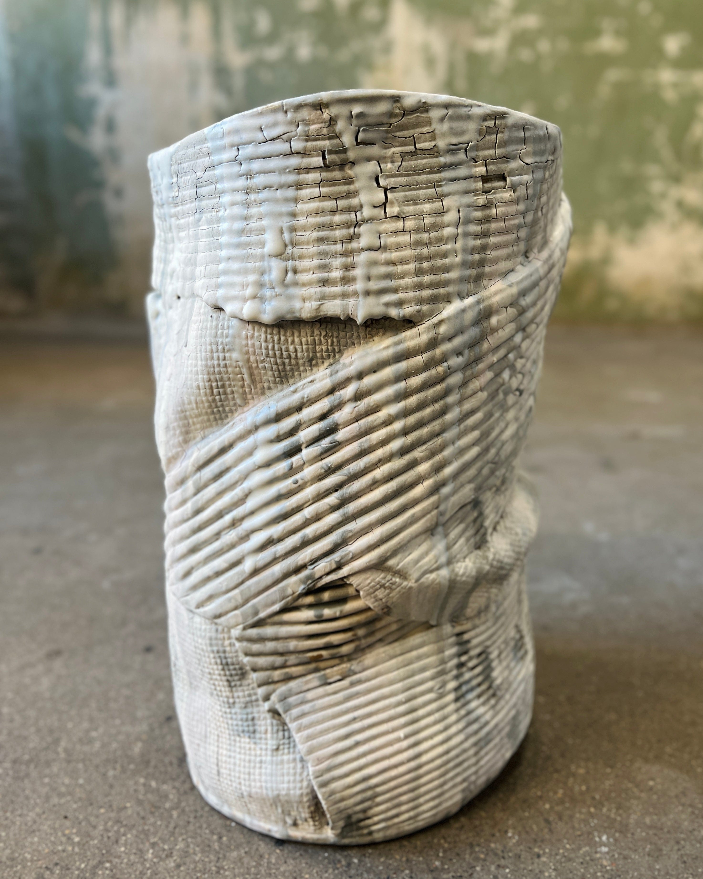 Textured ceramic vase with a wrapped design.