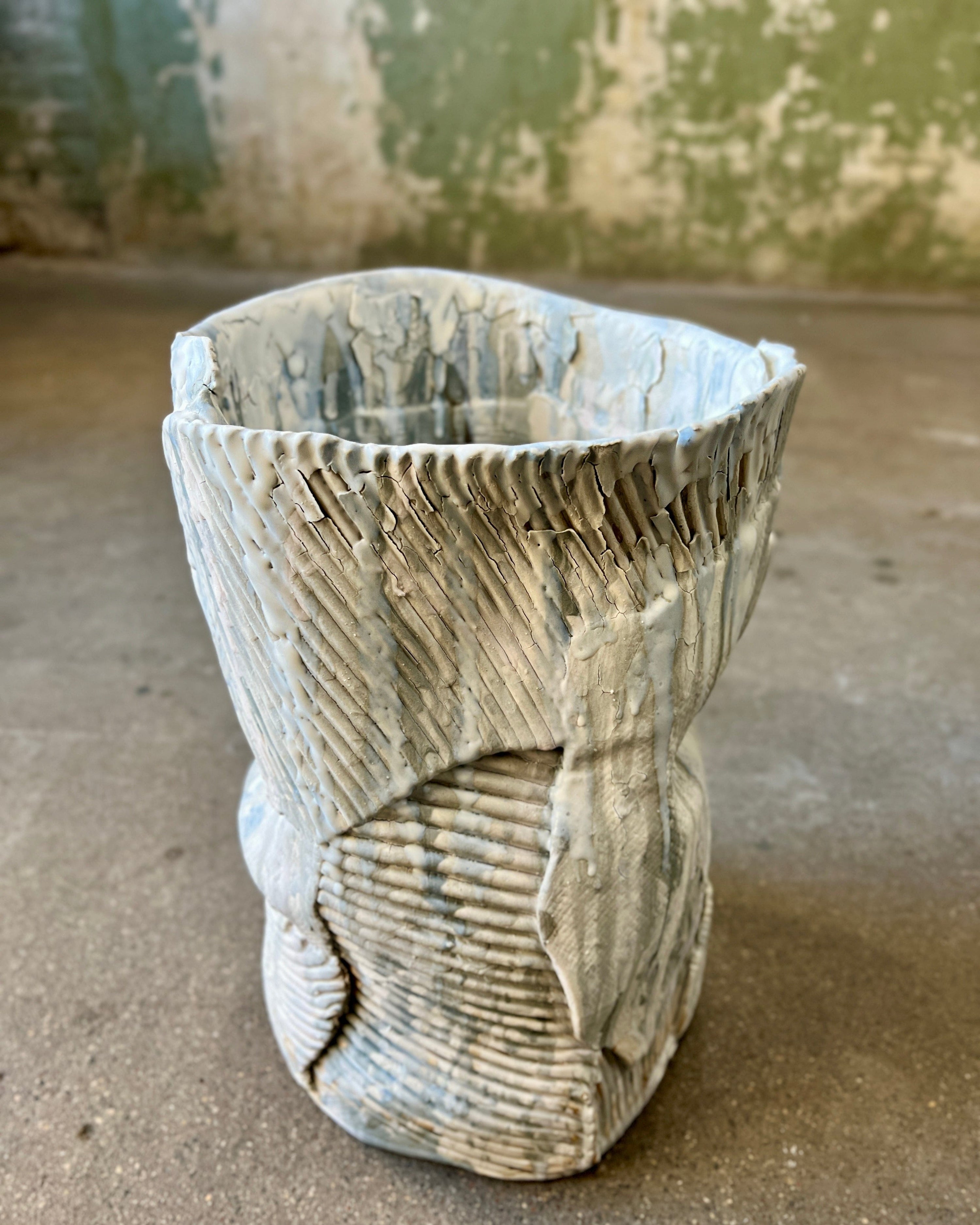 Textured, off-white ceramic vase.