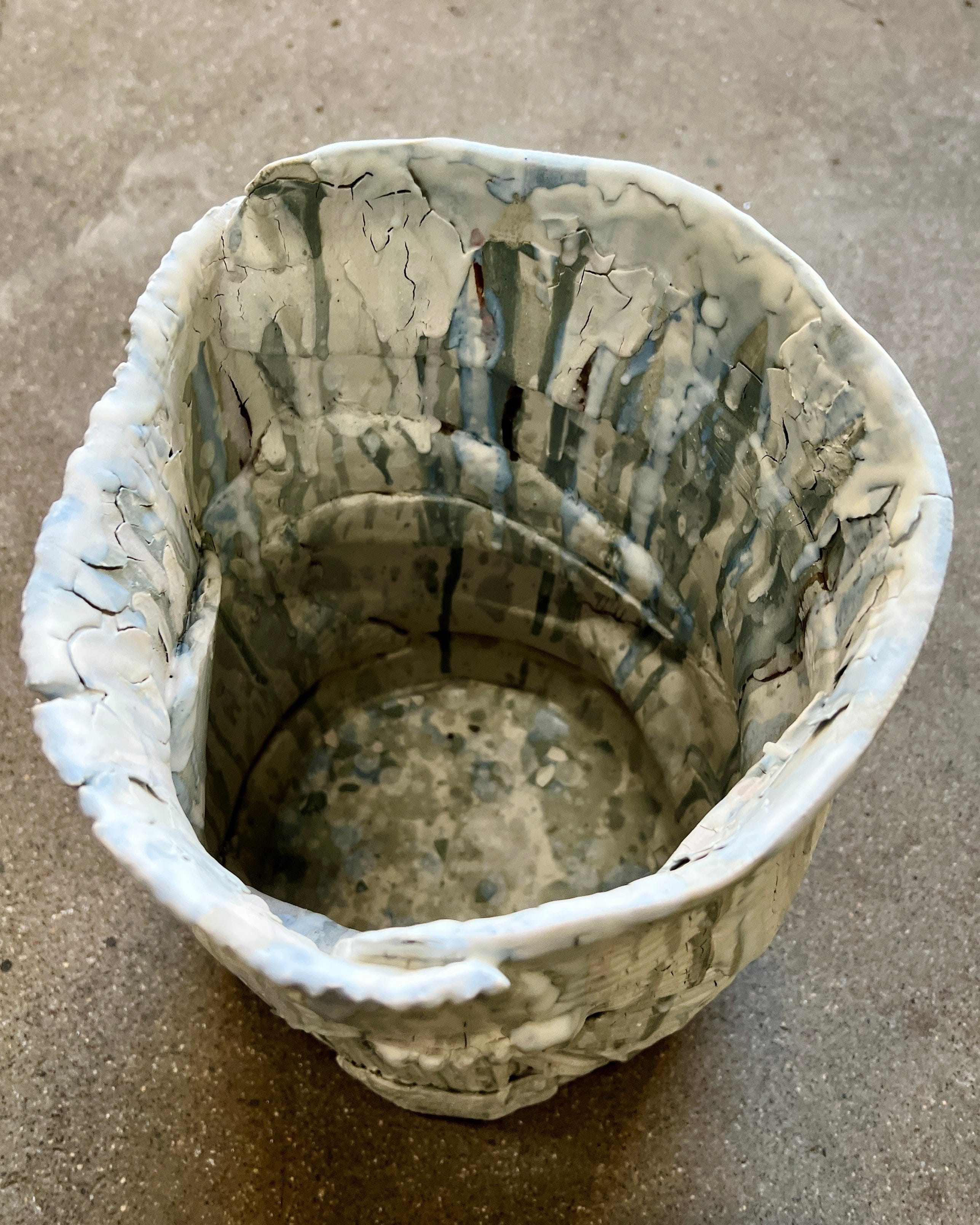 Ceramic bowl with textured white and gray glaze.