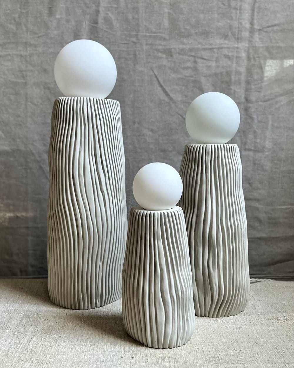Three decorative lamps with white globe tops.
